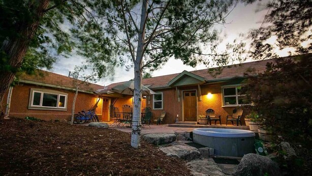 A residential property with a patio area, a hot tub, and outdoor seating.