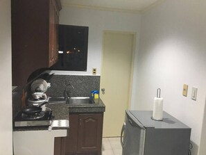 Een koelkast, een kookplaat, een waterkoker, een rijstkoker