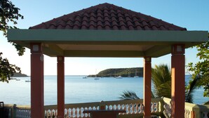 A gazebo with a tiled roof overlooking a calm sea with boats. - Dos Palmas-3Bdrm, 2Ba, Walk One Block to Caribbean,Malecon,restaurants,etc (Vieques)