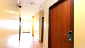 A hallway with a wooden door marked "409" and a tiled floor.