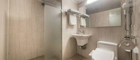 A modern bathroom with a glass-enclosed shower, a sink, and a toilet.