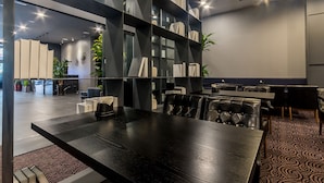 A modern conference room with a large table, leather chairs, and a bookshelf. - Pyeongtaek Stay Hotel (Pyeongtaek)