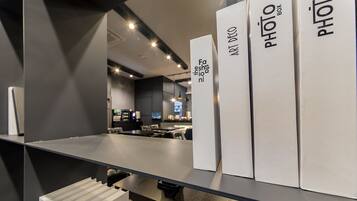 A modern interior with a glass partition and a counter displaying photo boxes.