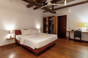 A bedroom with a wooden bed, a desk, and a wardrobe. - Enkosa Modern Villa (Siem Reap)