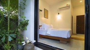 A bedroom with a bed, a window, and a door. - Enkosa Modern Villa (Siem Reap)