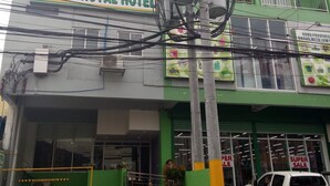 A multi-story building with a sign for "MEACO ROYAL HOTEL" on the ground floor. - Meaco Royal Hotel - Batangas City (Batangas City)