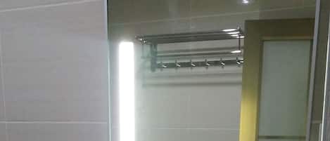 A bathroom with a white sink, a mirror, and a toilet.
