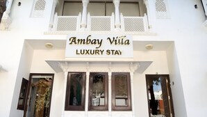 A sign for 'Ambay Villa Luxury Stay' with traditional architectural elements. - Ambay Villa (Udaipur)