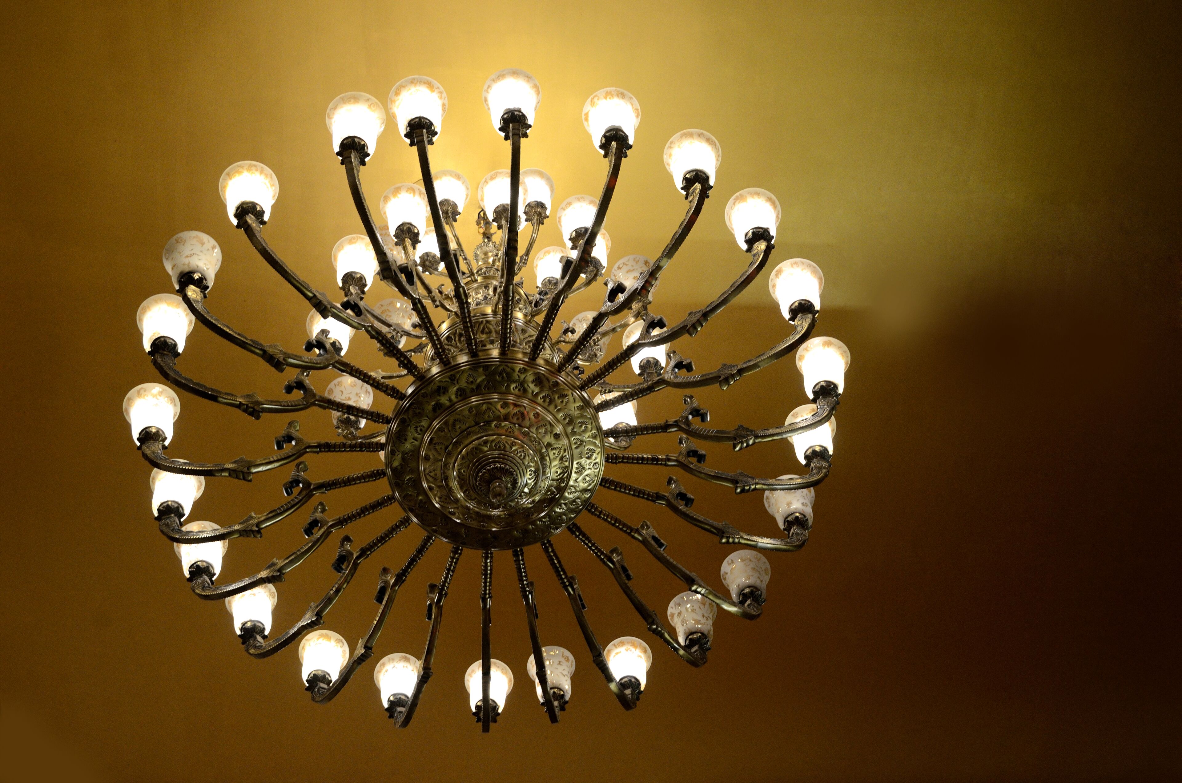 A chandelier with multiple light fixtures against a plain background.