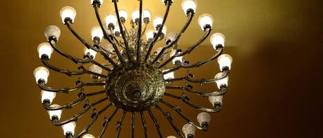 A chandelier with multiple light fixtures against a plain background.