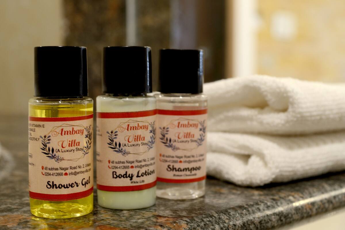 Three bottles of Ambay Villa body care products on a countertop.