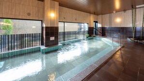 A modern indoor swimming pool with a wooden ceiling and tiled walls. - Grandvrio Hotel Nara Wakura (Tenri)