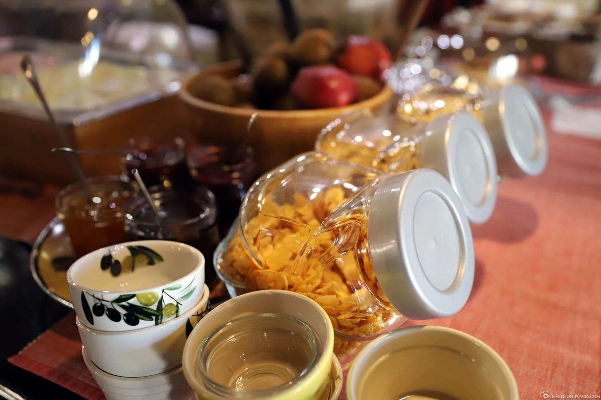 A buffet table with various food items and containers.