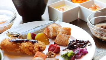 A plate of food with various items including fish, vegetables, and meat.