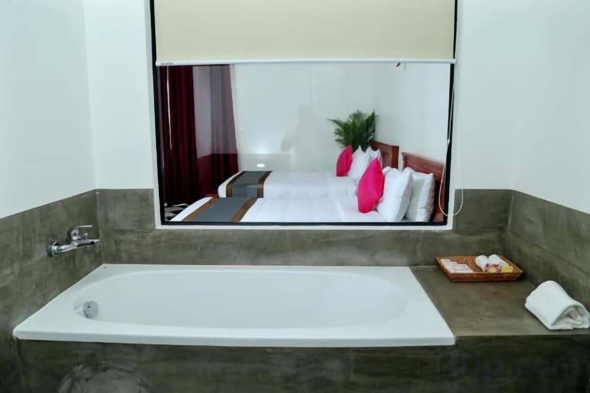 Bathroom | Designer toiletries, hair dryer, slippers, towels