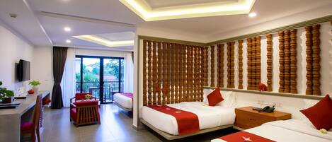 A modern hotel room with two beds, a desk, and a seating area.