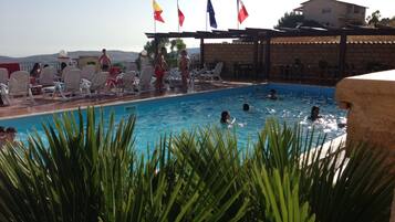 Seasonal outdoor pool, pool loungers