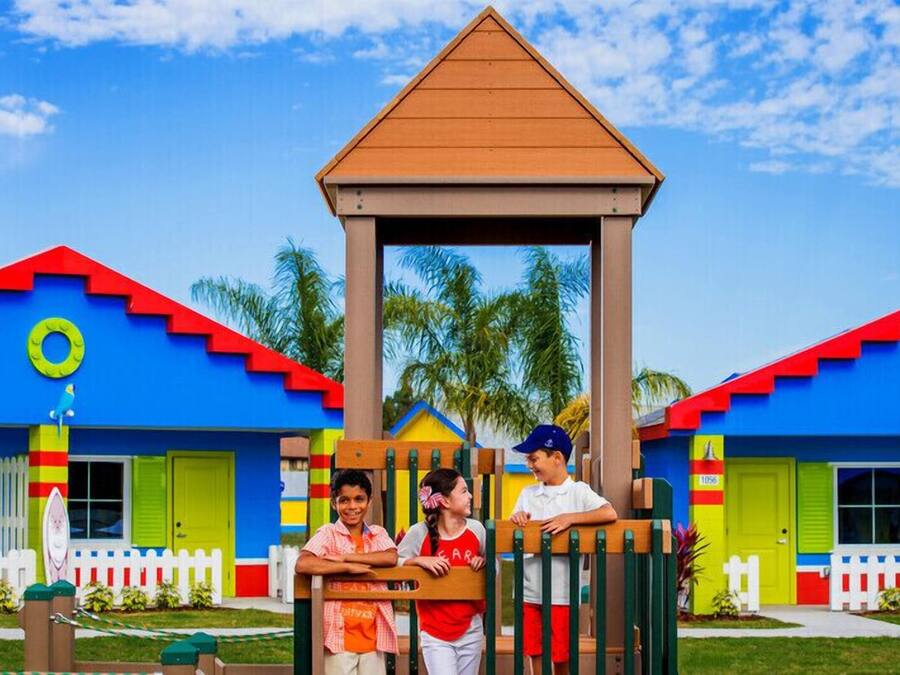 A colorful building with a play structure in front.