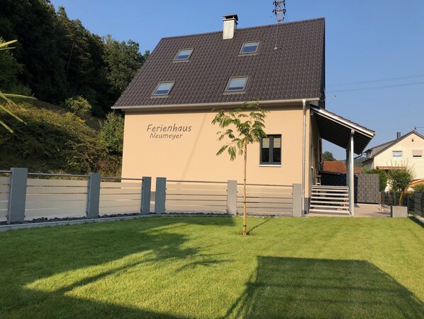 A two-story building with a sloped roof, labeled "Ferienhaus Neumeyer."