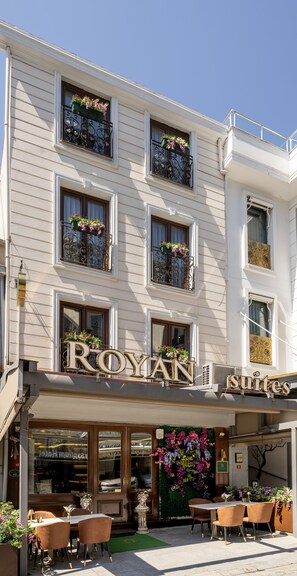 A hotel with a sign reading "ROYAN suites" and balconies with flower boxes. - Royan Suites (Istanbul)