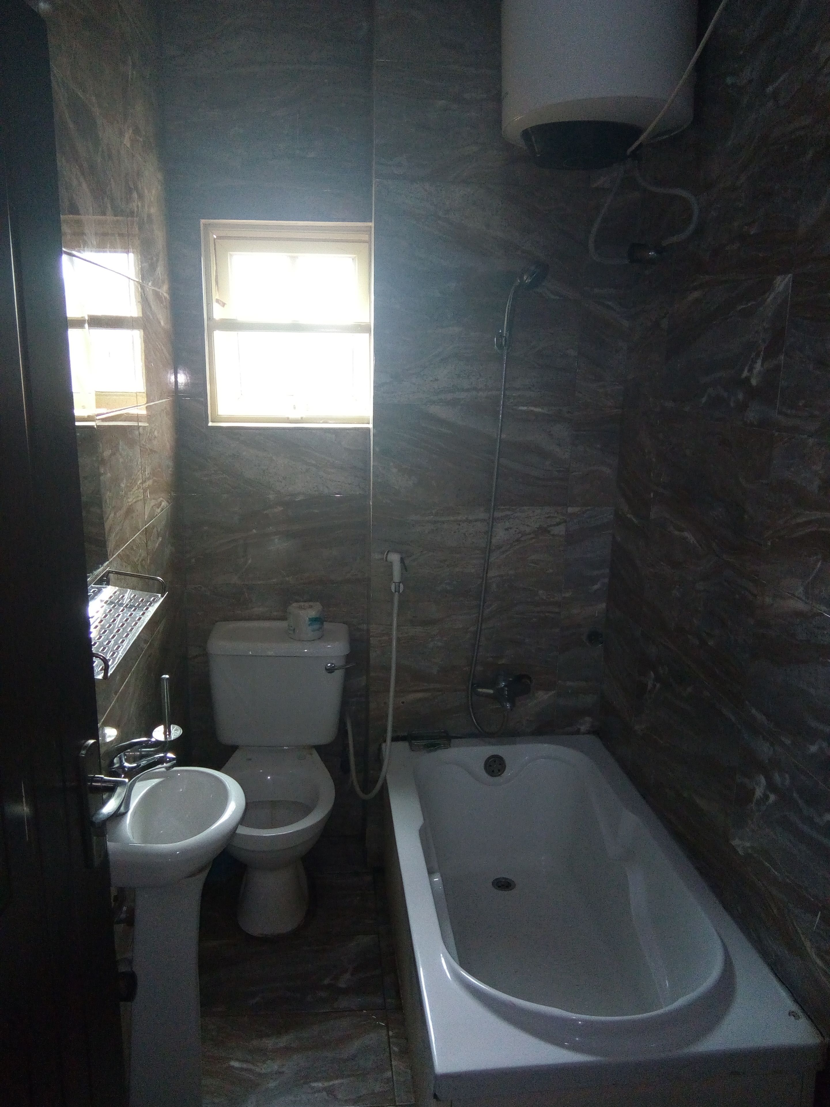 Ein kleines Badezimmer mit Toilette, Waschbecken und Badewanne.