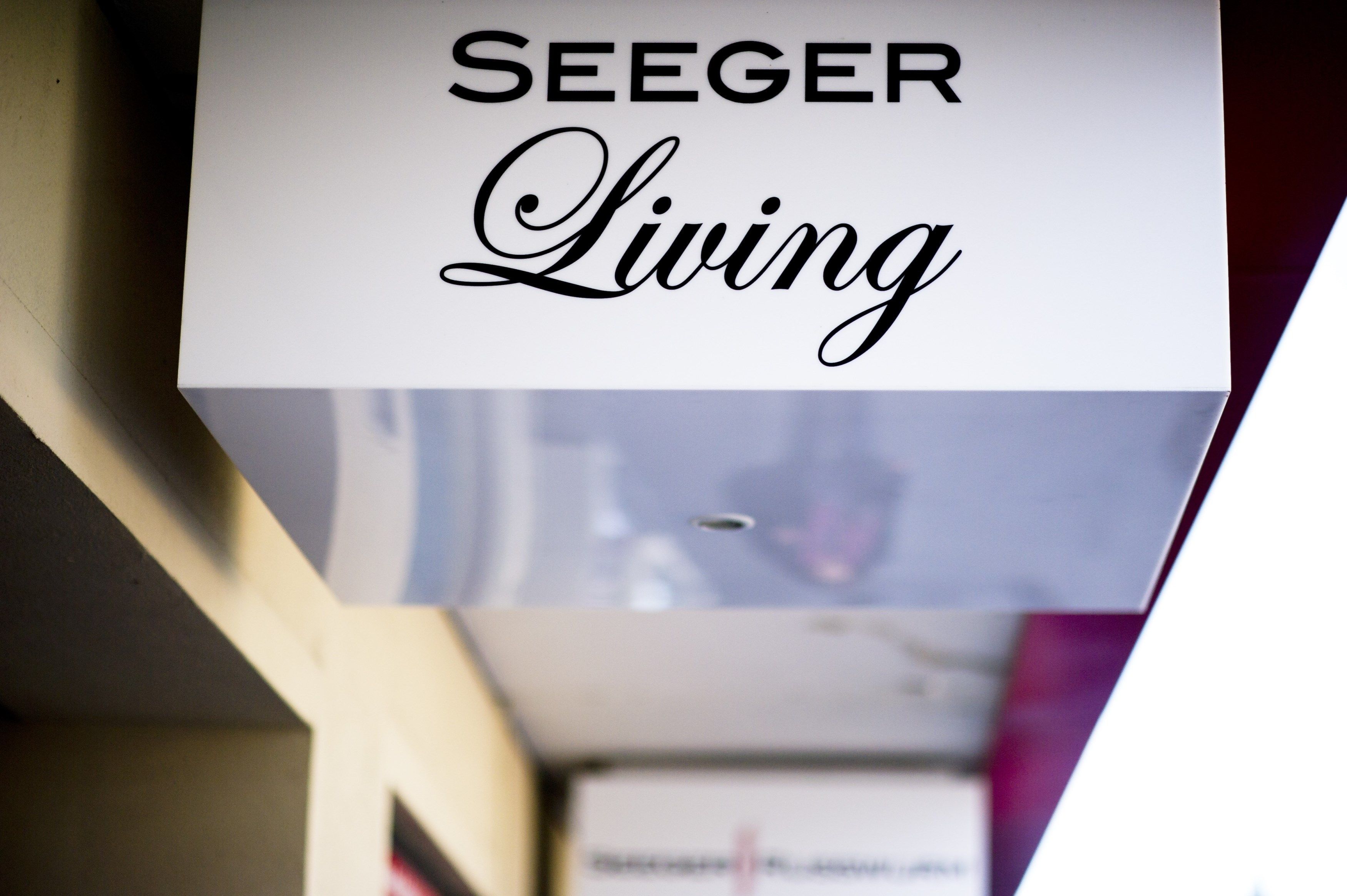 A sign with the text "SEEGER Living".