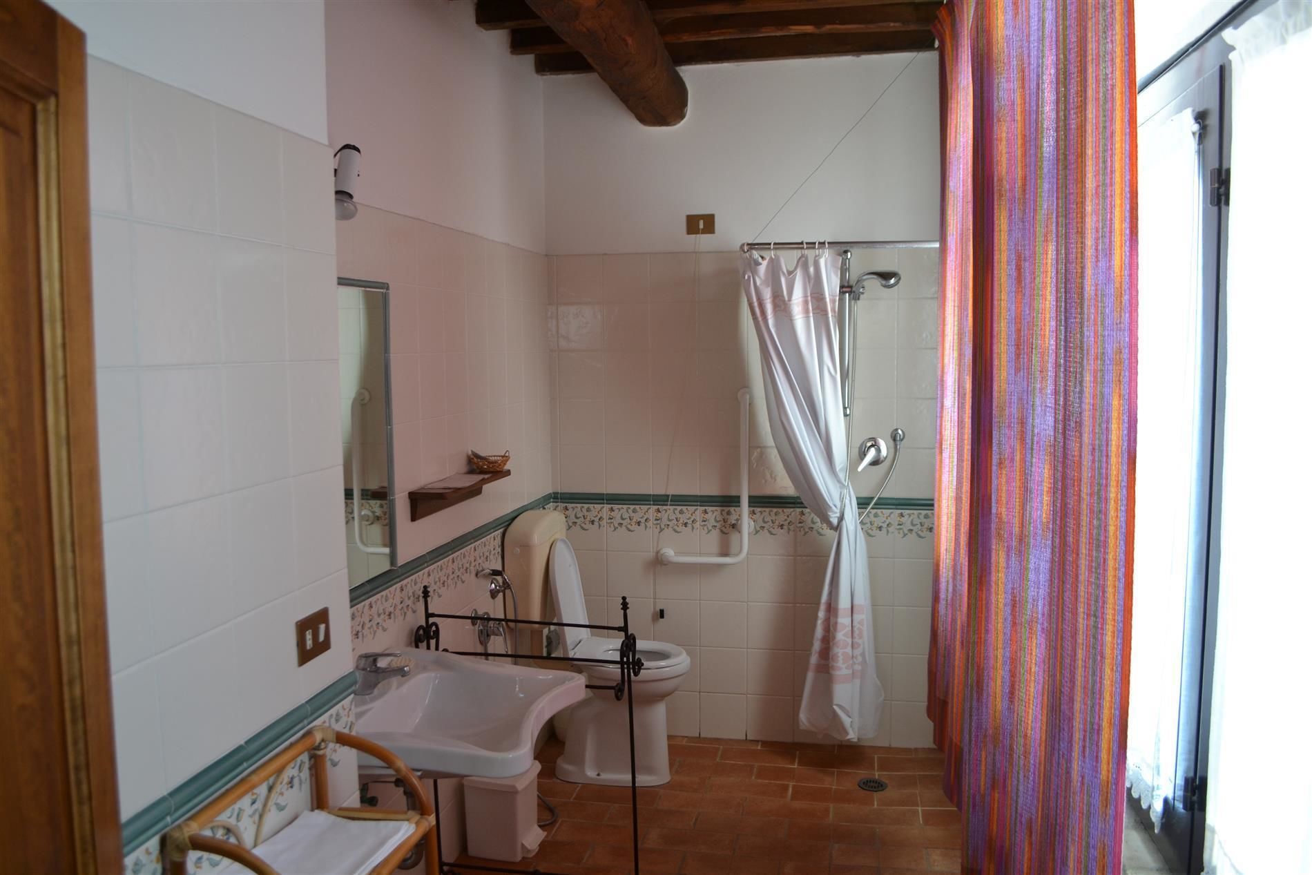 A bathroom with a bathtub, toilet, and sink.