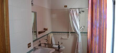 A bathroom with a bathtub, toilet, and sink.
