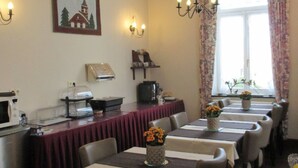 A dining area with tables set for a meal, a coffee machine, and a microwave on the counter. - Villa Esperanza (Tongeren)