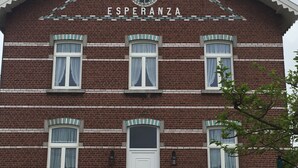 A two-story brick building with a white door and windows, labeled "VILLA ESPERANZA". - Villa Esperanza (Tongeren)