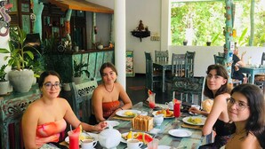 A group of people dining at a table with various dishes and drinks. - Hungry Lion Sigiriya (Sigiriya)