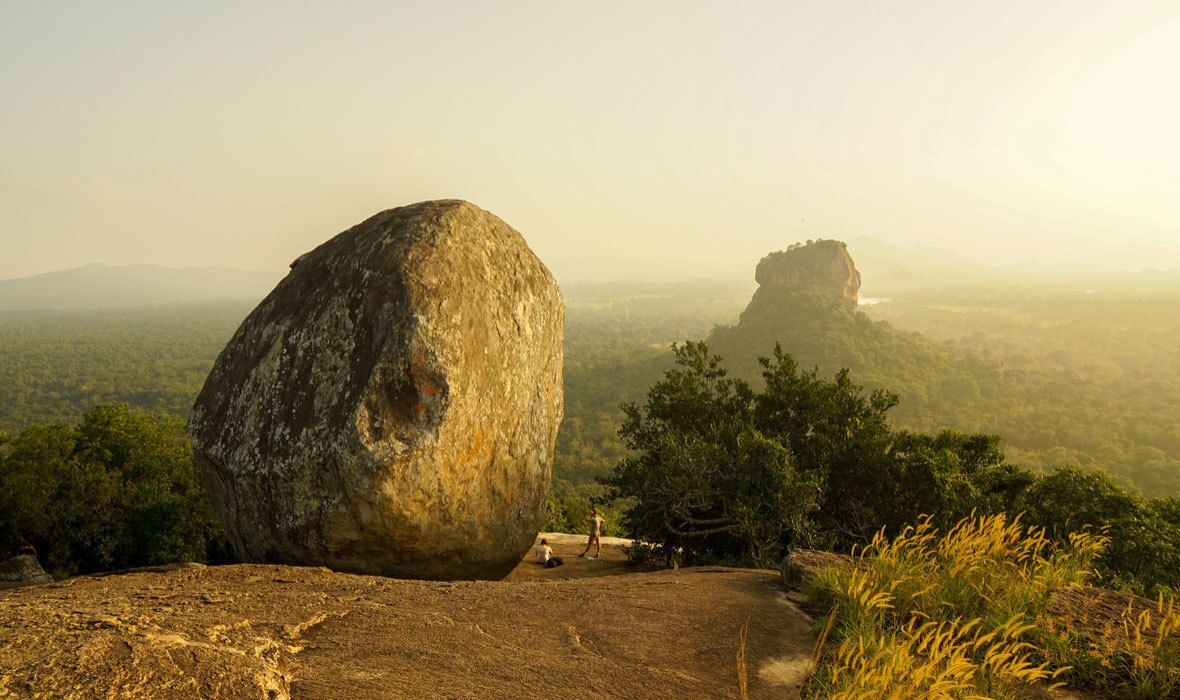 A large rock formation with a clear view of the surrounding landscape.