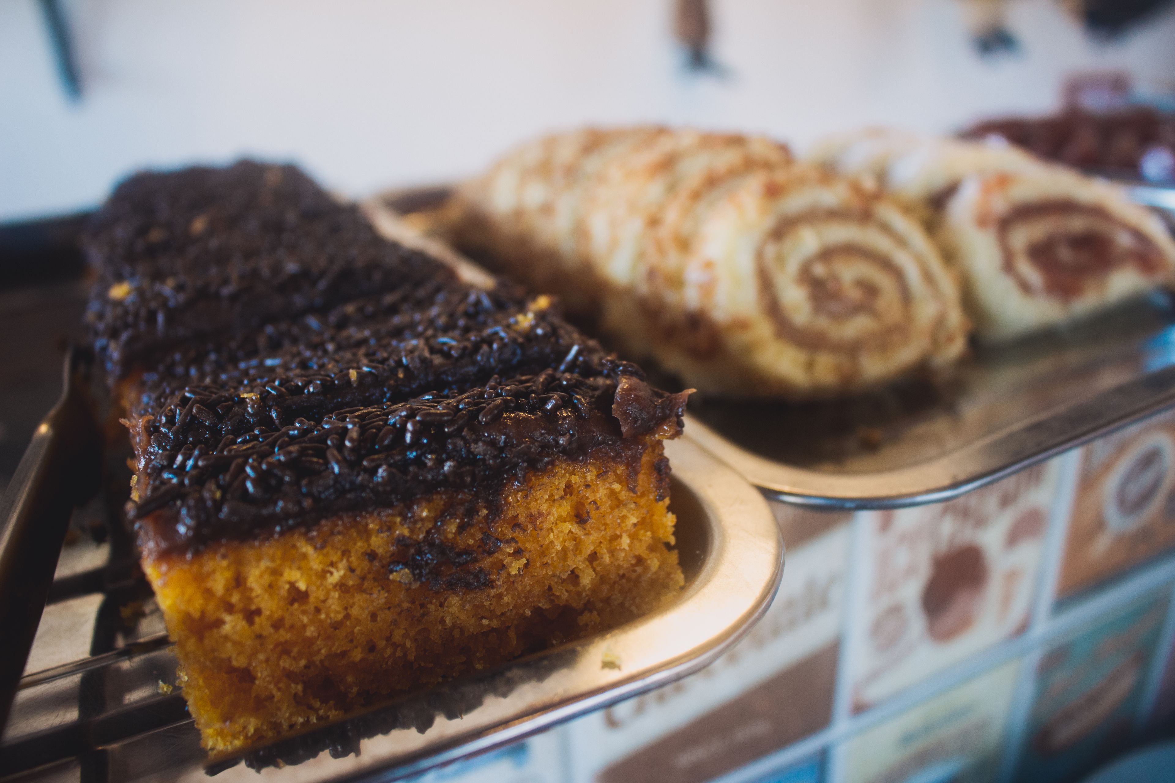 A slice of chocolate-topped cake on a plate.