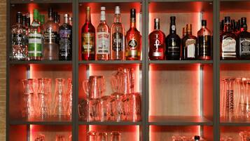 A bar area with shelves of liquor bottles and glassware.