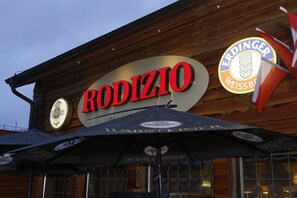 A restaurant named "RODIZIO" with a sign featuring "ERDINGER WEISSBRÄU" and a logo.