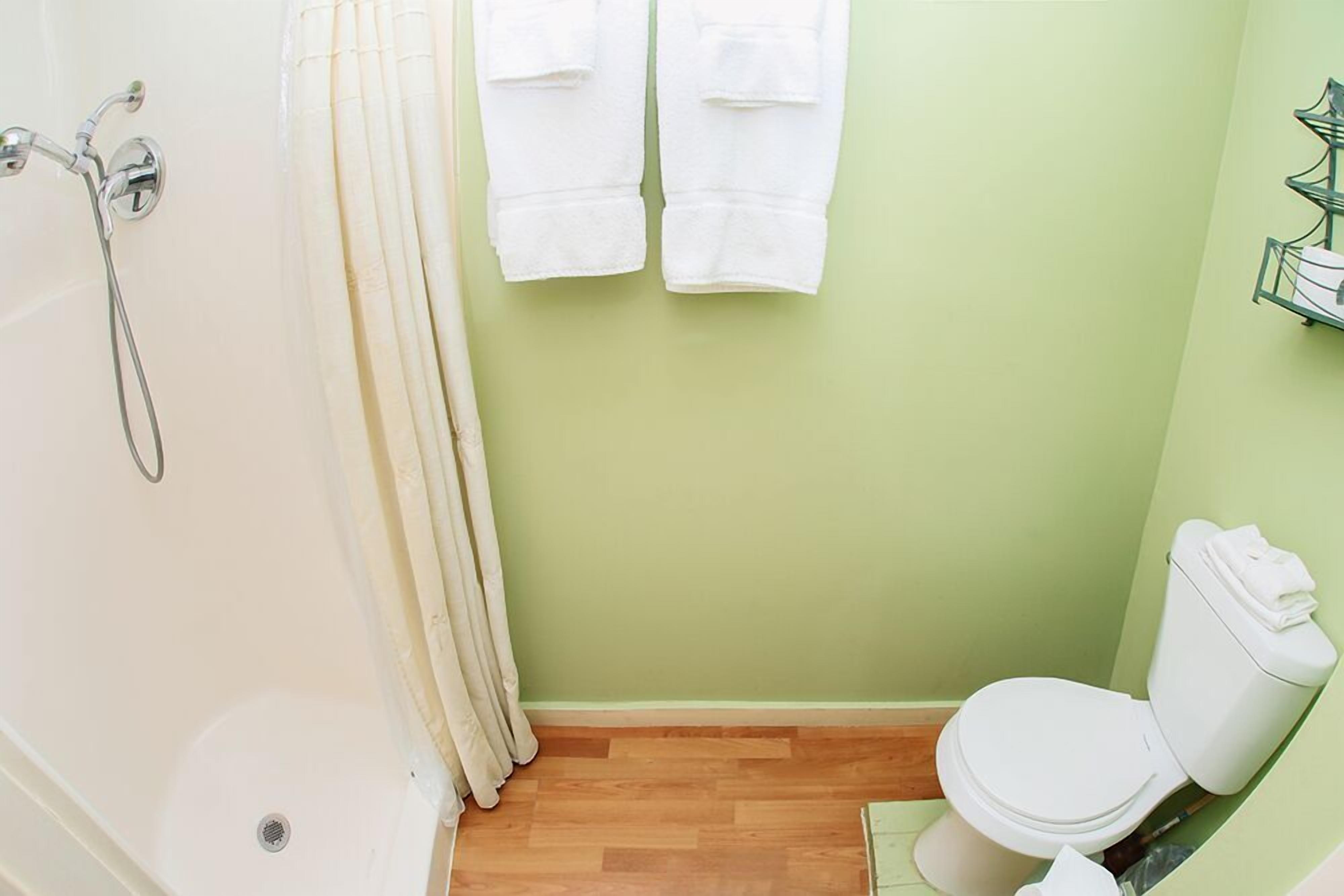 A bathroom with a bathtub, toilet, and a shower.