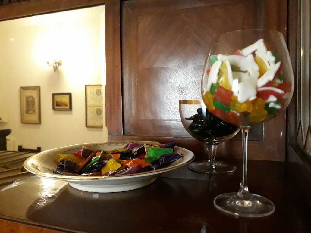 A dining table with a plate of colorful food and a glass of a beverage.