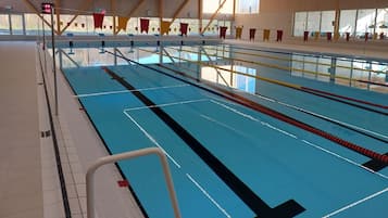 Swimmers can enjoy a refreshing dip in the pool, surrounded by multiple lanes and lane dividers.