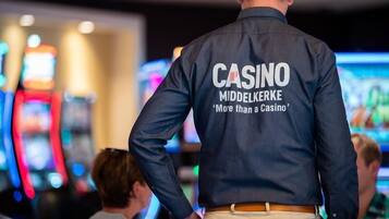 A person wearing a casino uniform with "CASINO" and "Middelkerke" visible on the back.