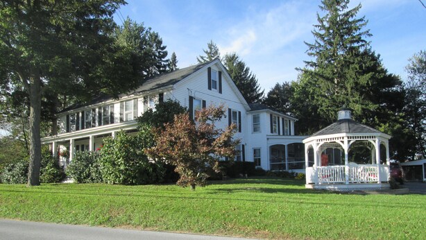 A large white house with a porch and a gazebo. - Buck's Homestead B&B (Montgomery)