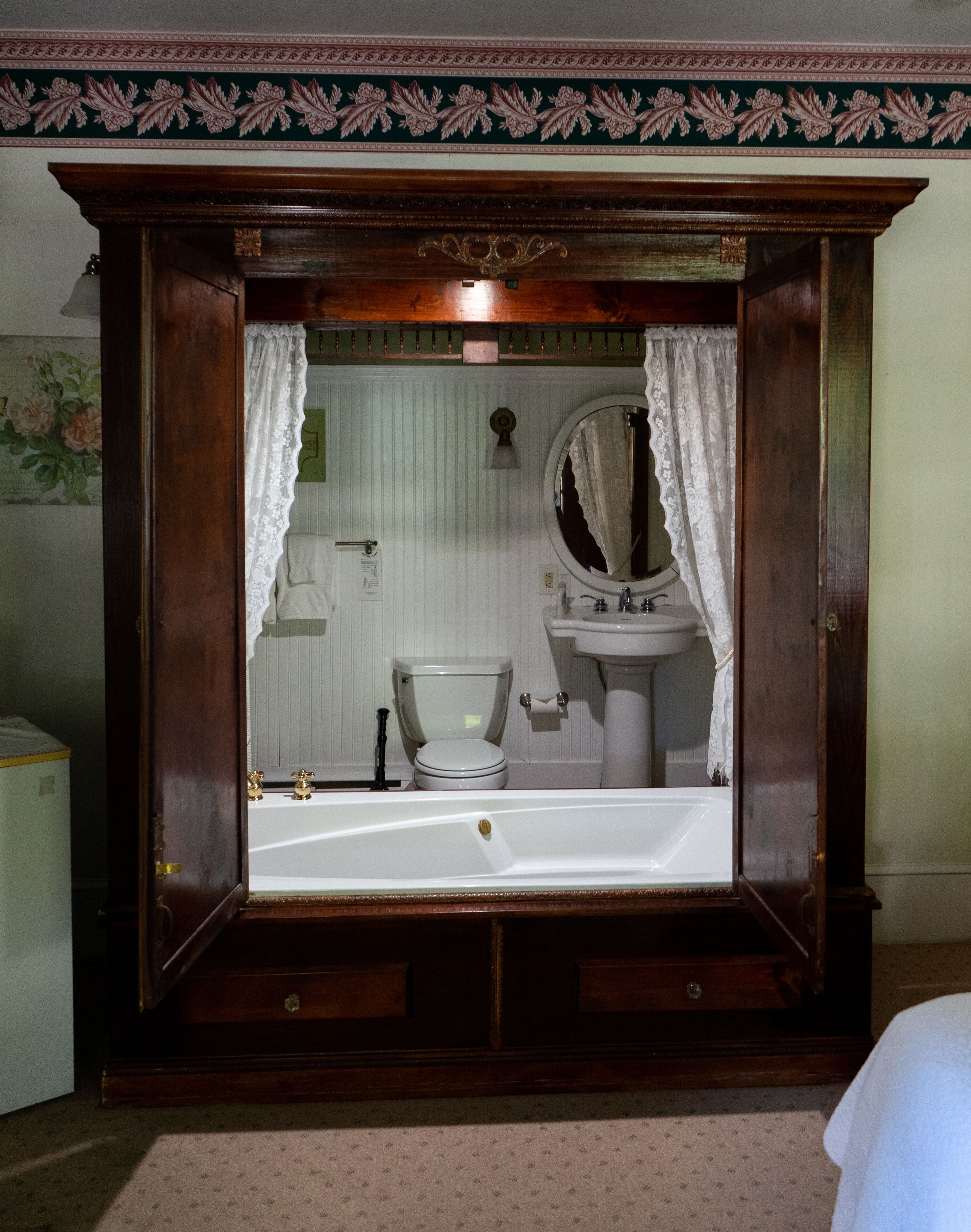 A bathroom with a large mirror, a sink, and a toilet.