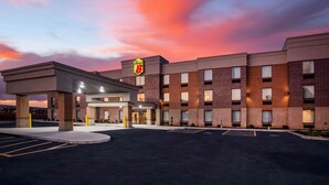 A hotel with a brick facade, a 'Super 8' sign, and a parking lot.