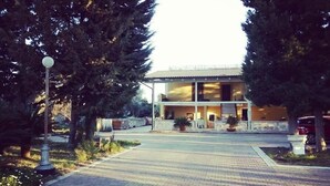 A two-story building with a flat roof, surrounded by trees and a paved driveway. - Verdeoliva Bed & Breakfast (Bari)