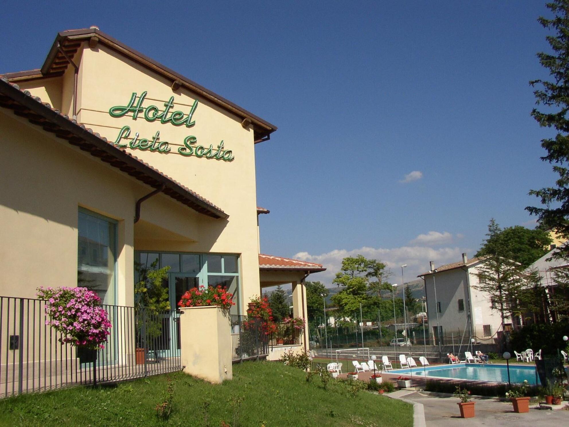 A hotel named "Hotel Luisa Sosa" with a swimming pool and outdoor seating area.