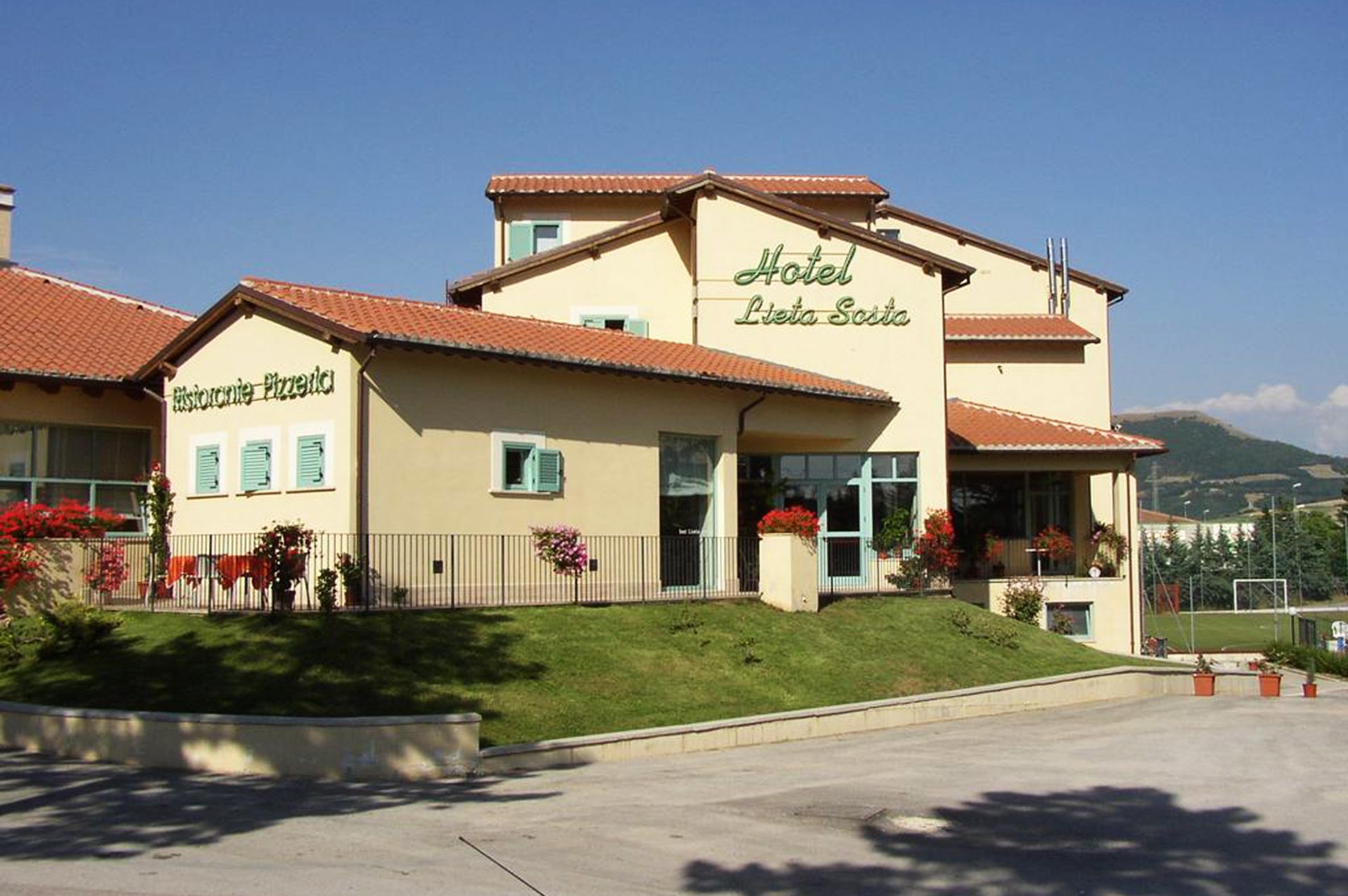 A two-story building with a sign reading "Hotel Leita Sotto."