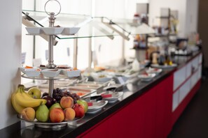 A buffet with various fruits and dishes.