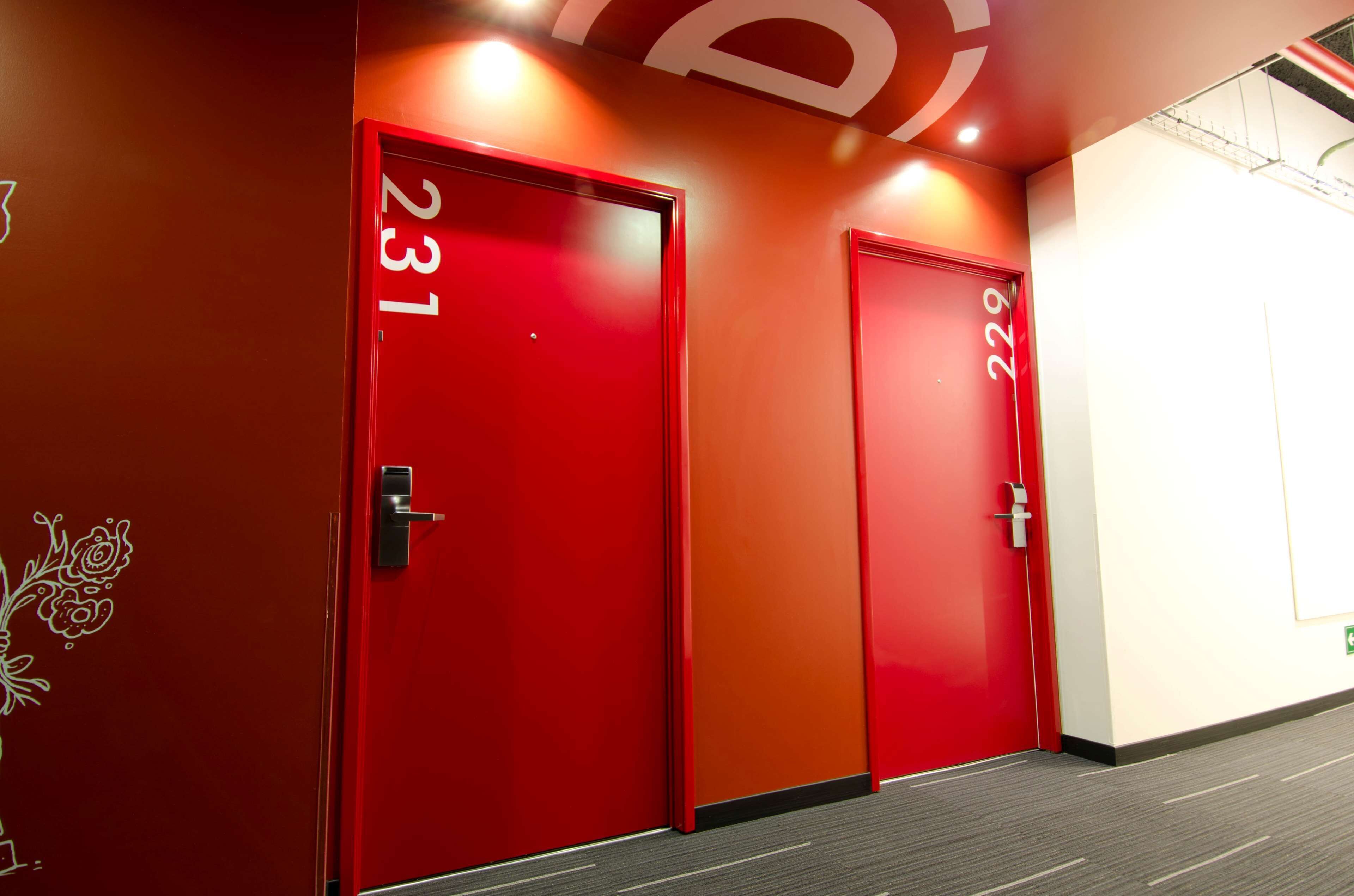 Two red doors with numbers 231 and 229, indicating hotel rooms.