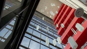 A modern building with large windows and a red facade. - Ramada Encore by Wyndham Aguascalientes (Aguascalientes)