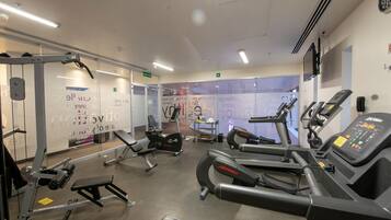 Ett gym med löpband, motionscyklar och styrketräningsmaskiner.
