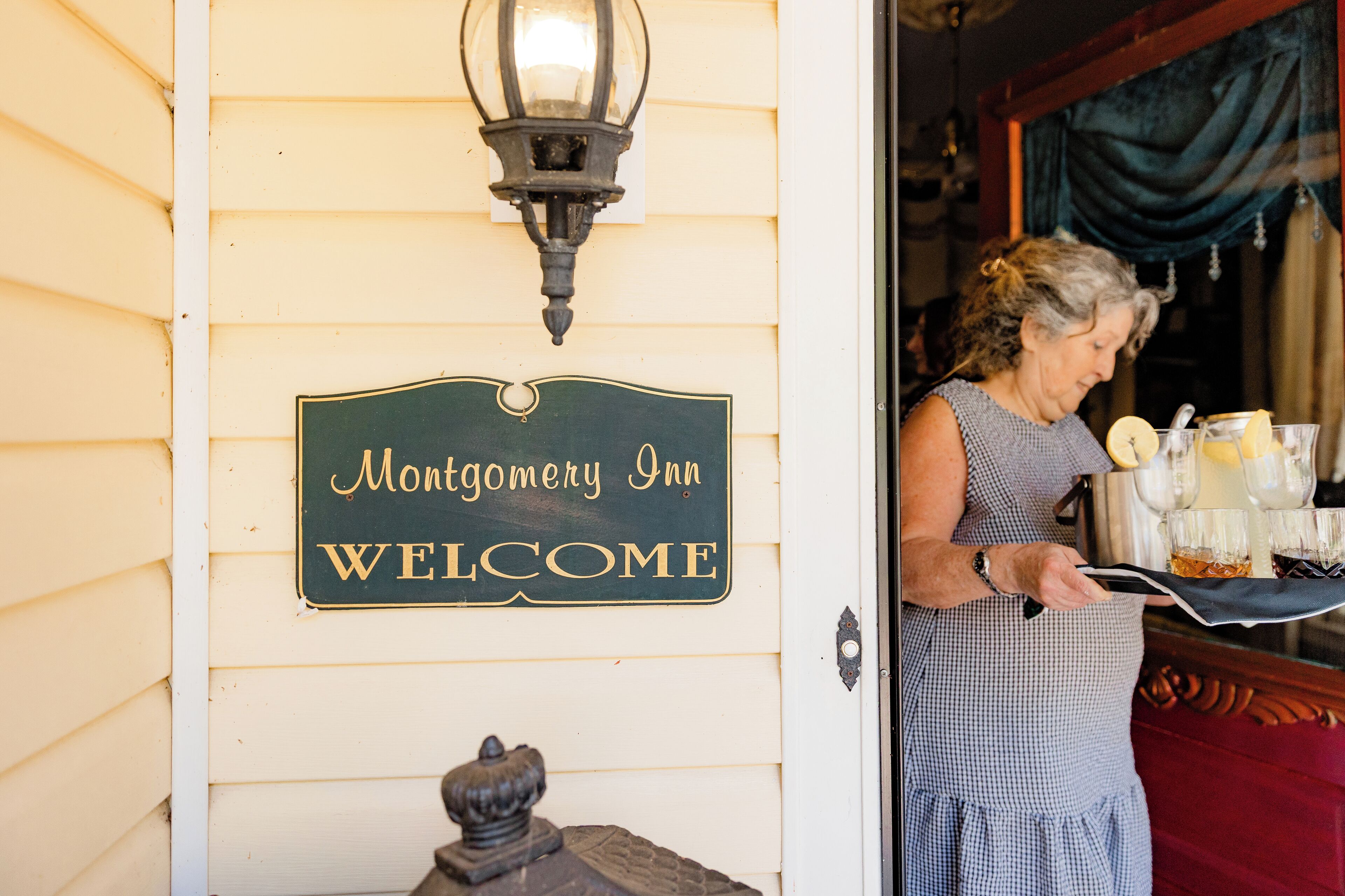 A sign reading "Montgomery Inn Welcome" on a building's exterior wall.